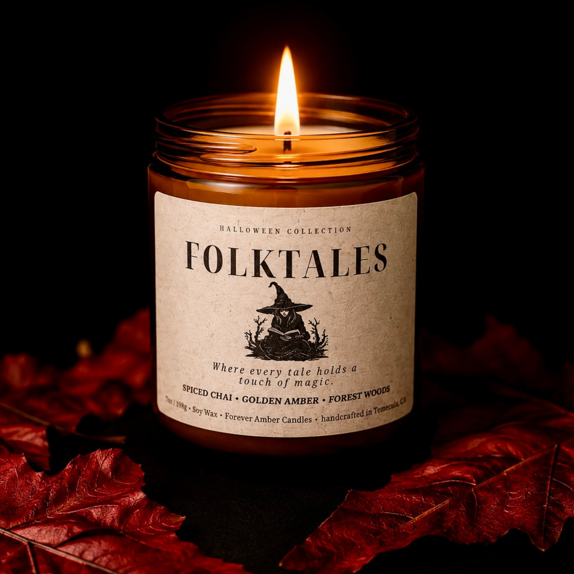 Lit Folktales 7 oz soy candle from the Forever Amber Candles Halloween Collection surrounded by red autumn leaves